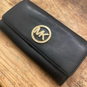 Black women’s Michael Kors wallet clutch holds check book and credit cards